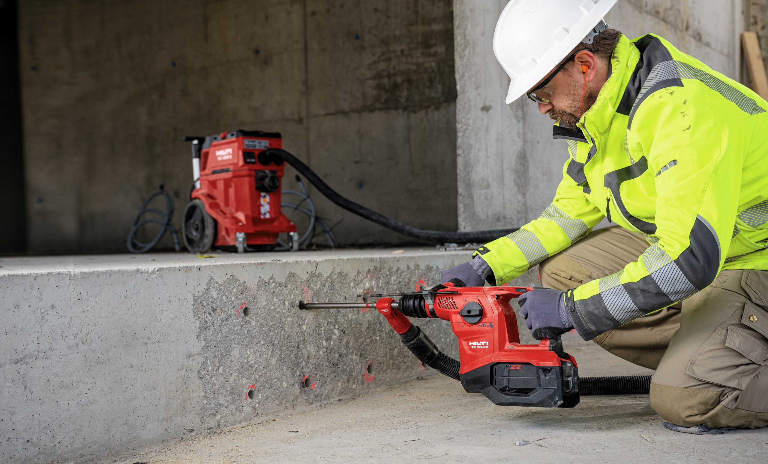 a rotary hammer drills through concrete