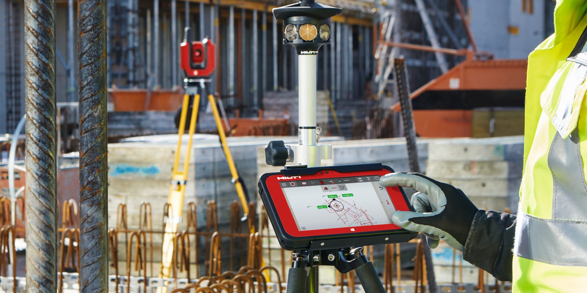 Construction worker using BIM-compatible layout tool to locate building elements on a jobsite