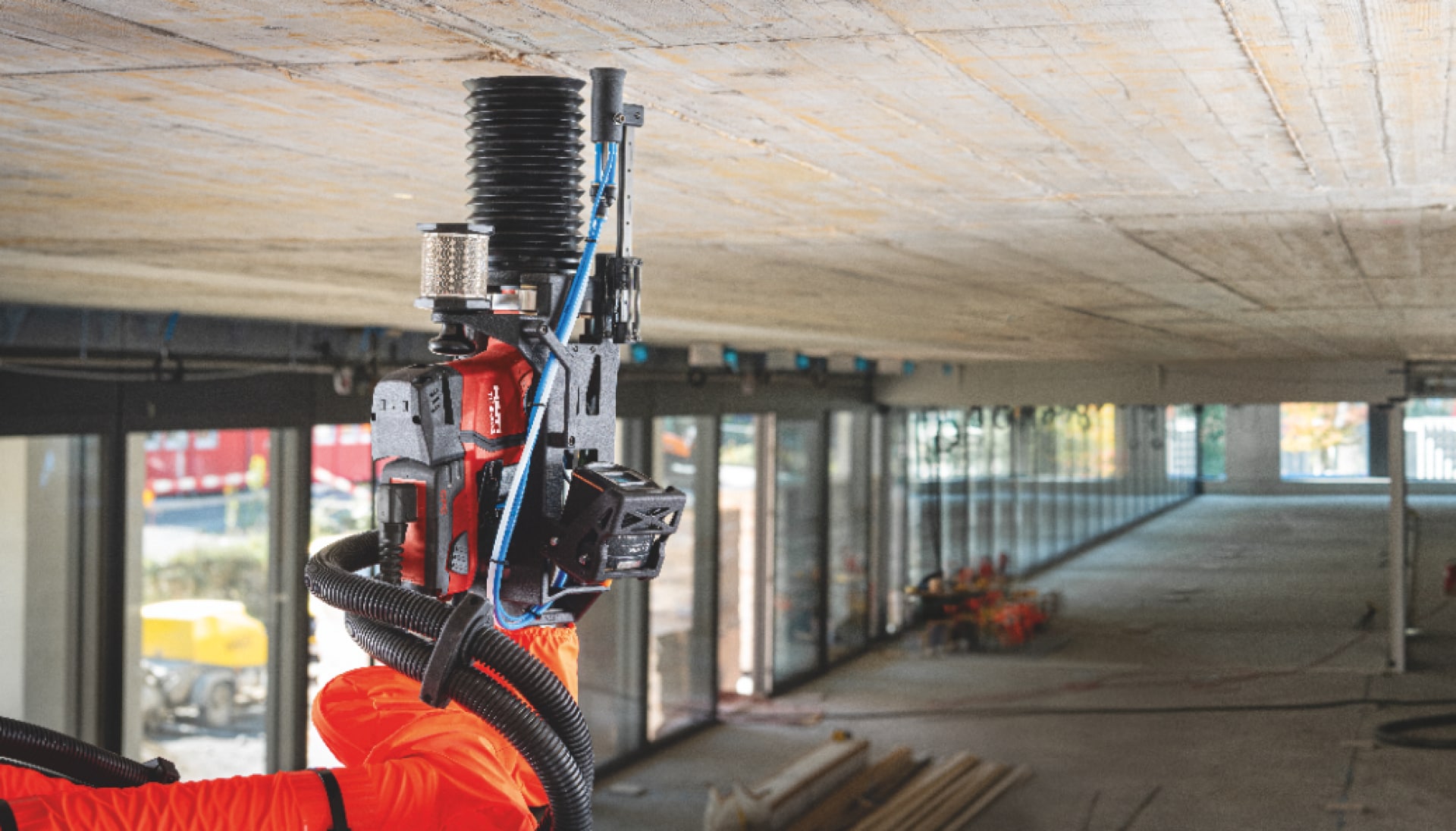 Concrete ceiling and construction robot drilling on a jobsite.