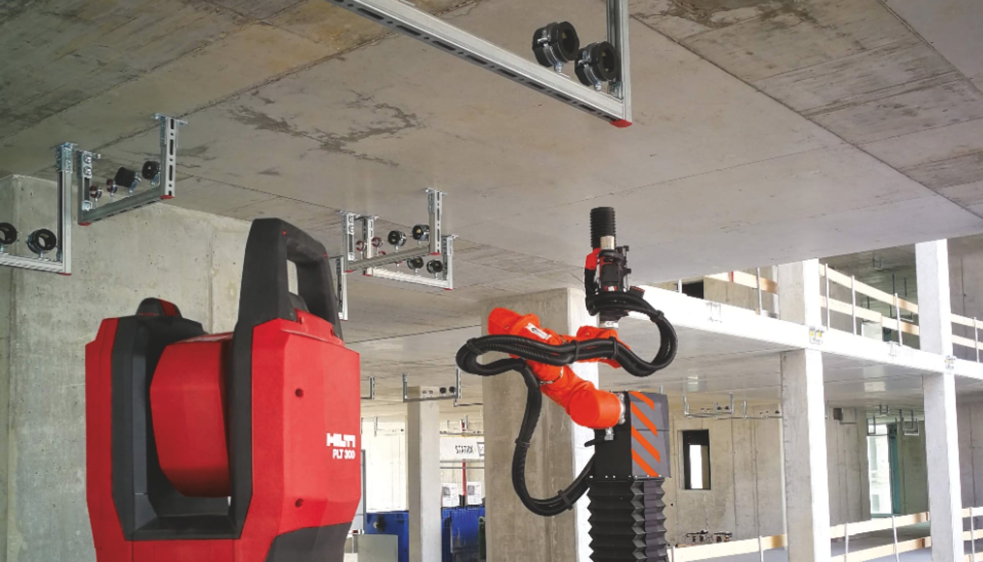 Hilti PLT 300 total station and Jaibot drilling robot on a construction site performing MEP installation.