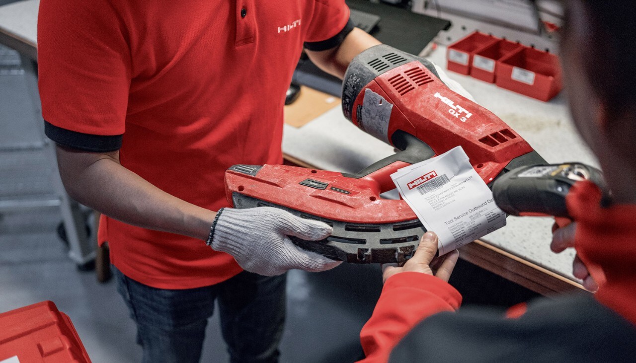 A Hilti service technician receives a tool for repair